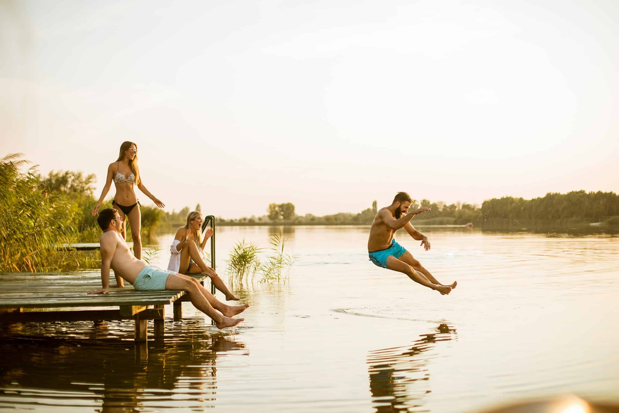 people jumping into lake