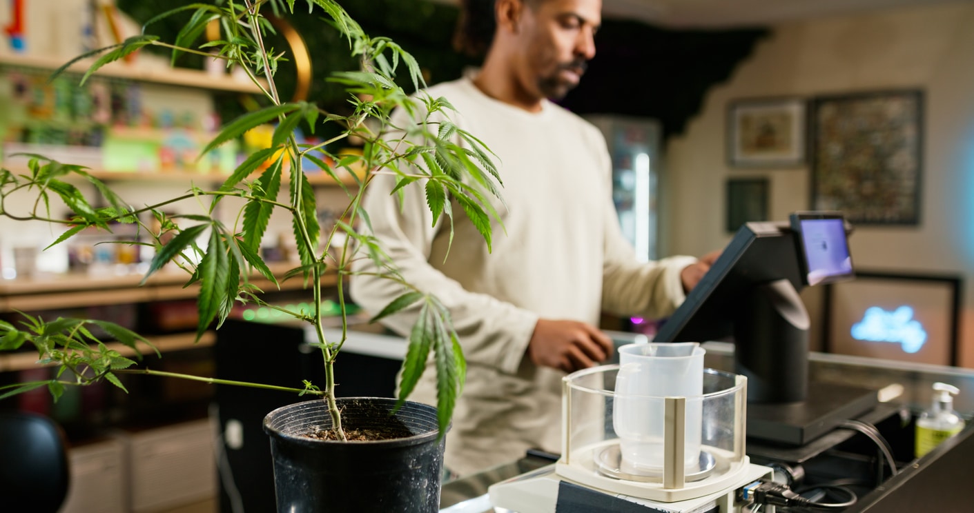 A budtender works inside of a retail cannabis shop in Oregon.
